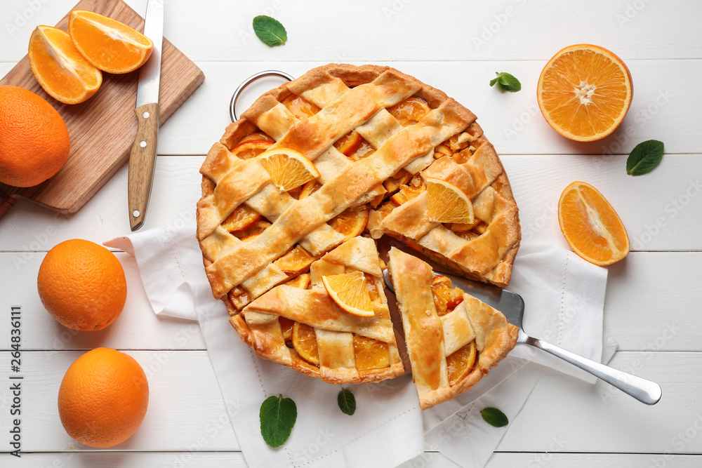 Tasty orange pie on table