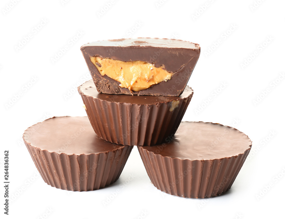 Tasty chocolate peanut butter cups on white background