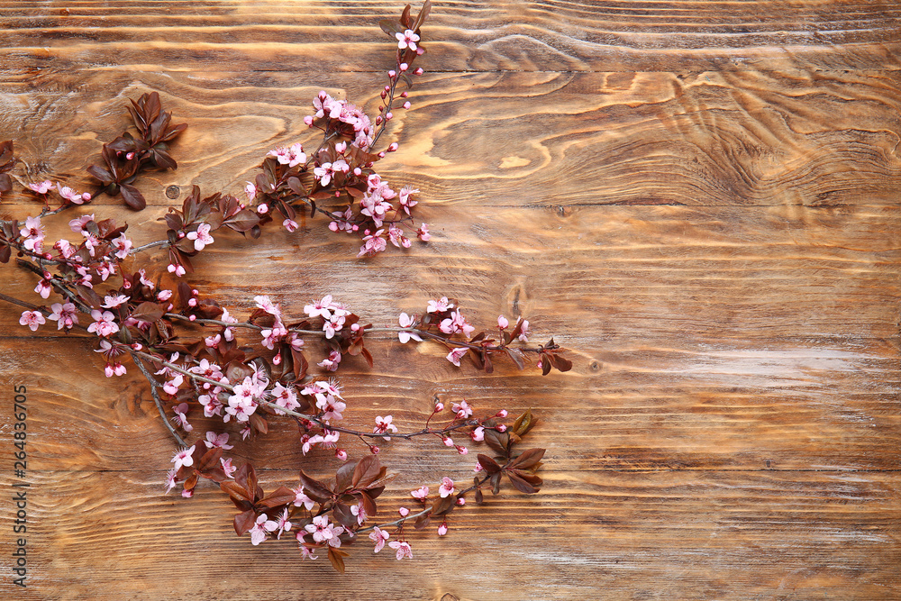 Beautiful blossoming branches on wooden background