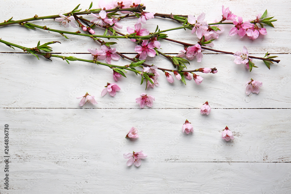 Beautiful blossoming branches on white wooden background