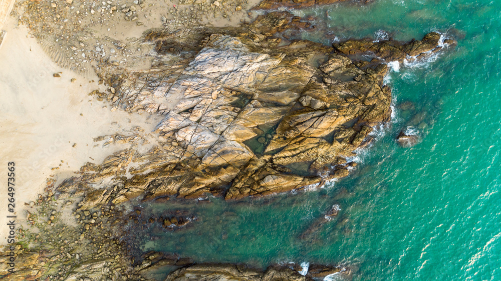 Aerial view drone shot of seascape scenic off beach in phuket thailand with wave crashing on the roc