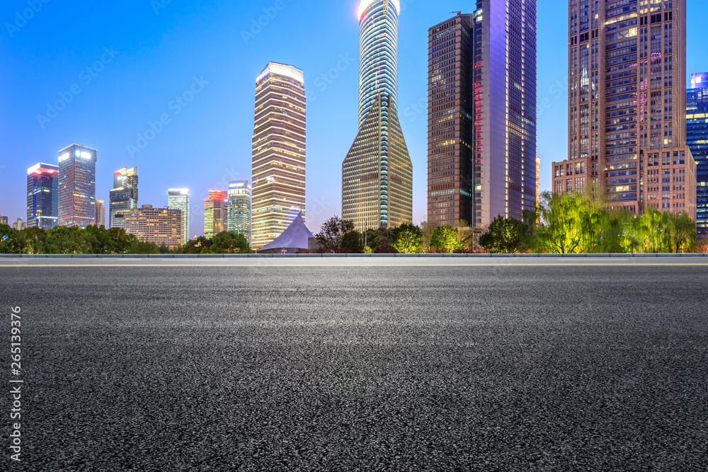 Shanghai modern commercial office buildings and asphalt road at night