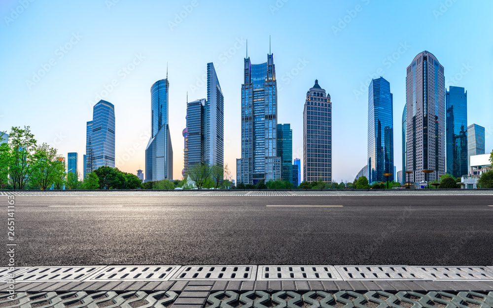 Shanghai modern commercial office buildings and empty asphalt road at night,panoramic view