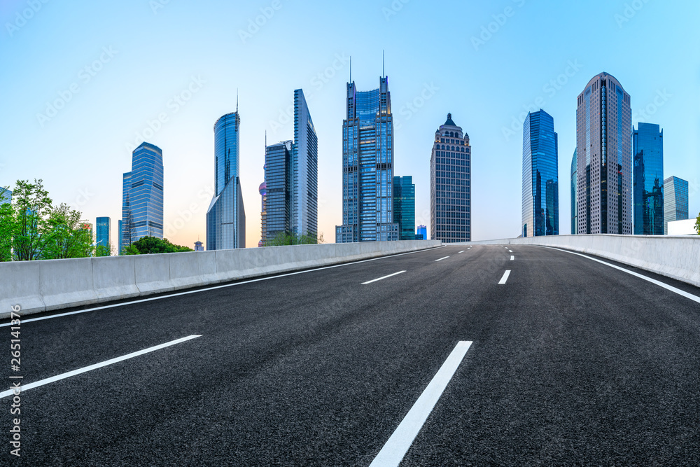 Shanghai modern commercial office buildings and empty asphalt road at night,panoramic view