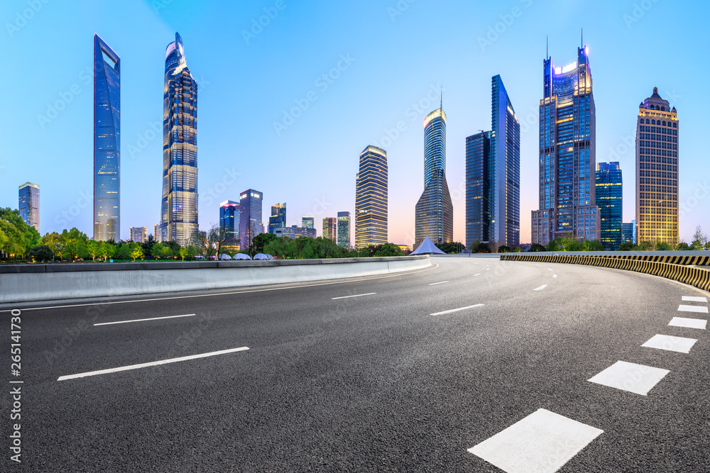 Shanghai modern commercial office buildings and empty asphalt road at night,panoramic view