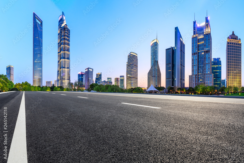 Shanghai modern commercial office buildings and empty asphalt road at night,panoramic view