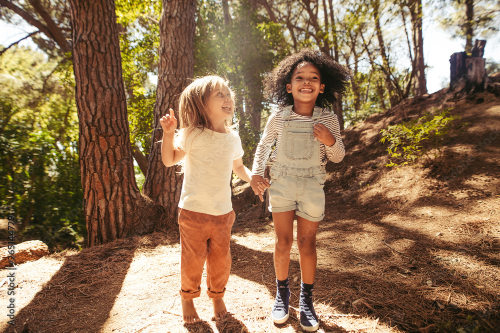 Smiling girls having fun in forest