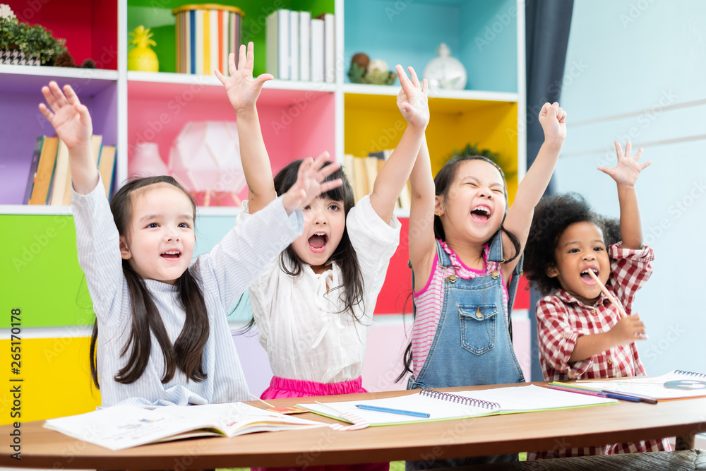 Group diversity kids studying at school, rising hands and enjoy in classroom, kids education concept