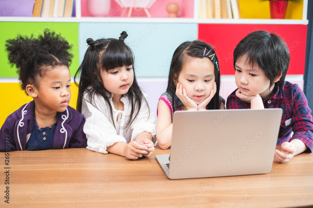 Group of students kids using laptop for learning in classroom, kids education concept