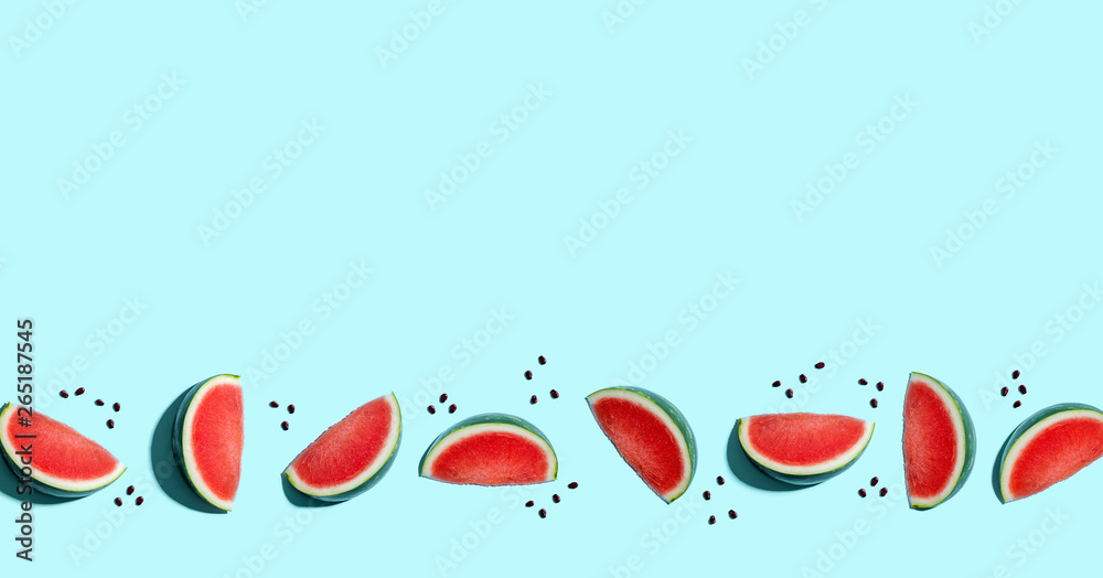 Sliced watermelons arranged on a blue background