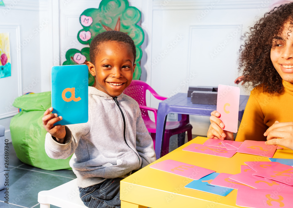 Boy show cursive letter learn with tactile cards