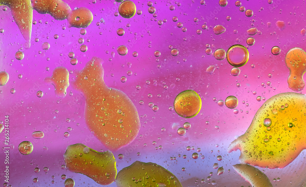 Colorful oil bubbles on a water surface, abstract background, macro.