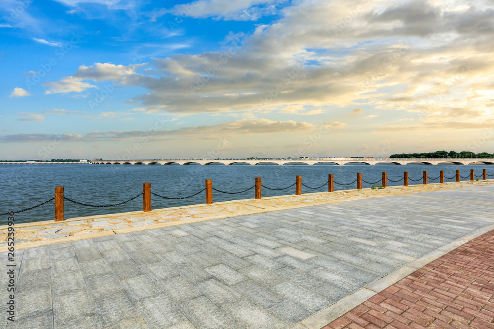 Beautiful lake and walkway with sky clouds at sunset