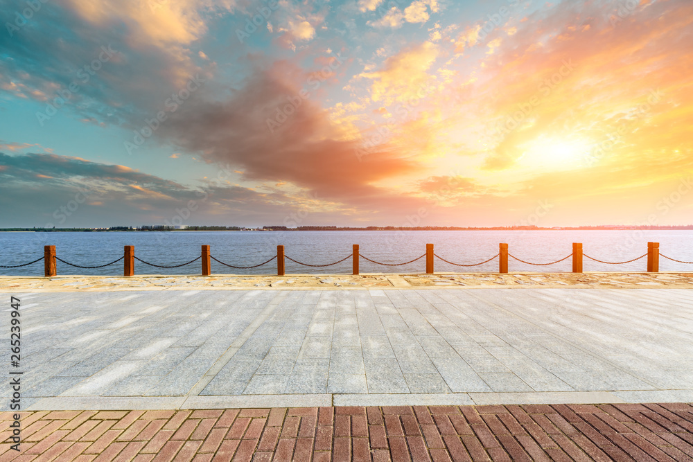 Beautiful lake and walkway with sky clouds at sunset