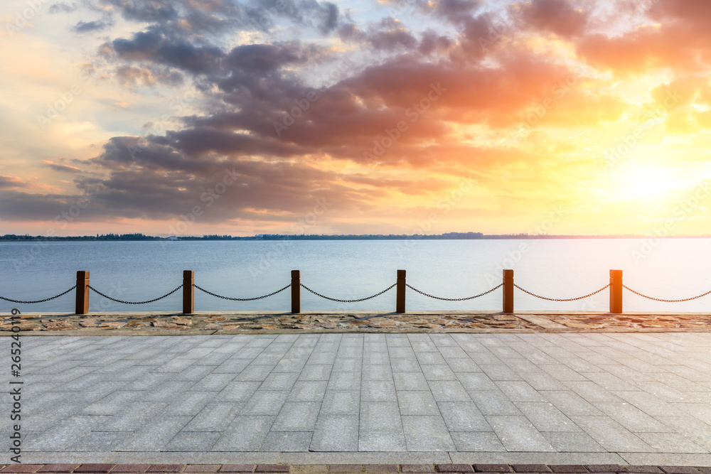 Beautiful lake and walkway with sky clouds at sunset