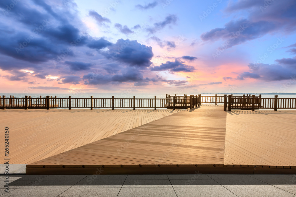 Lakeside wood floor platform and sky clouds at sunset