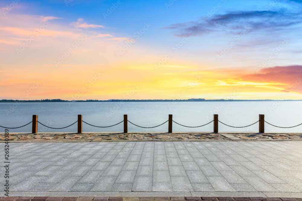 Beautiful lake and walkway with sky clouds at sunset