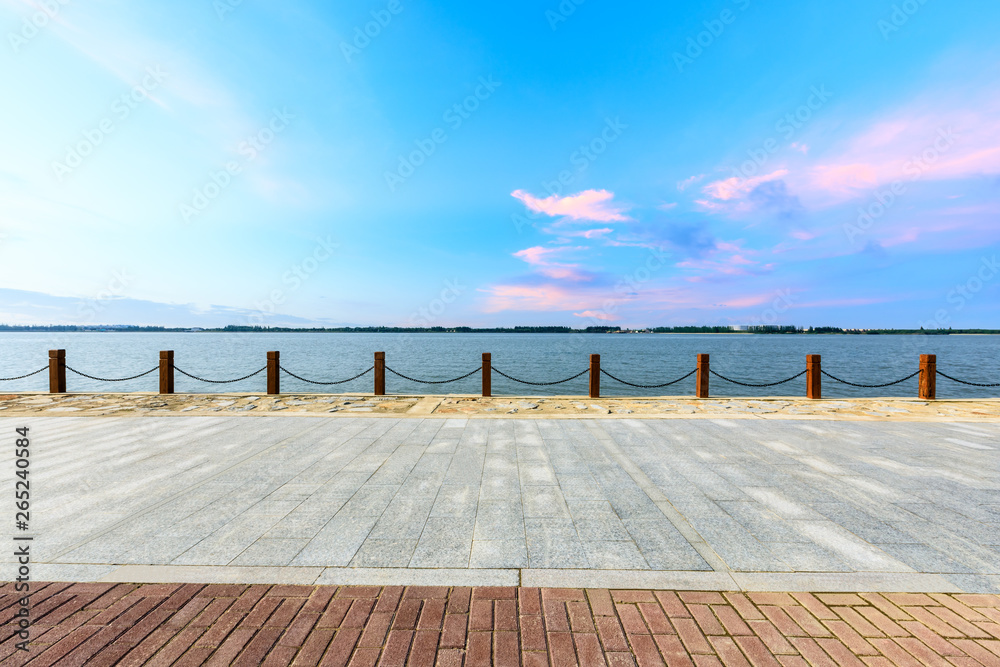 Beautiful lake and walkway with sky clouds at sunset