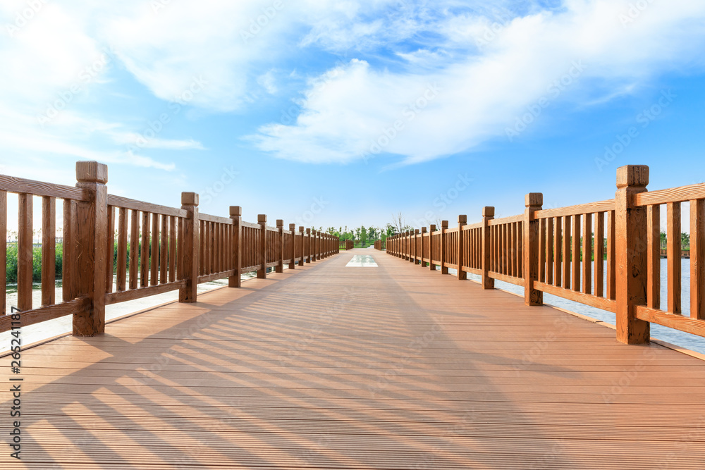 Empty boardwalk and beautiful clouds in city park