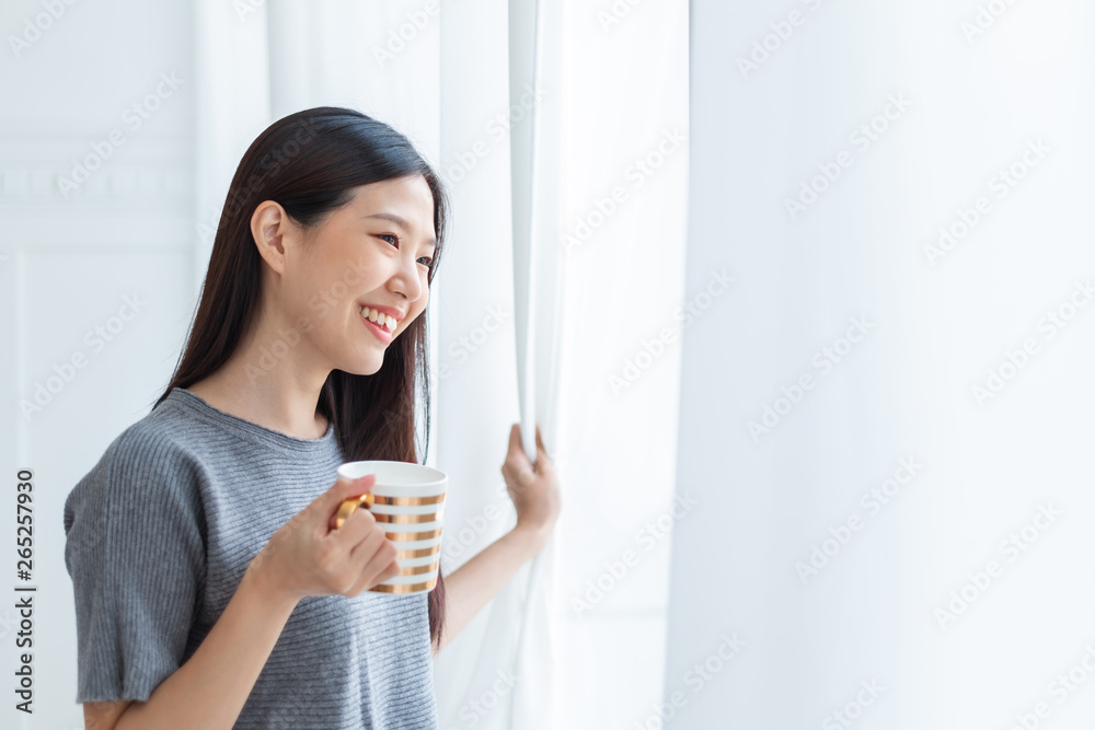 Asian woman drinking coffee in the morning after wake up