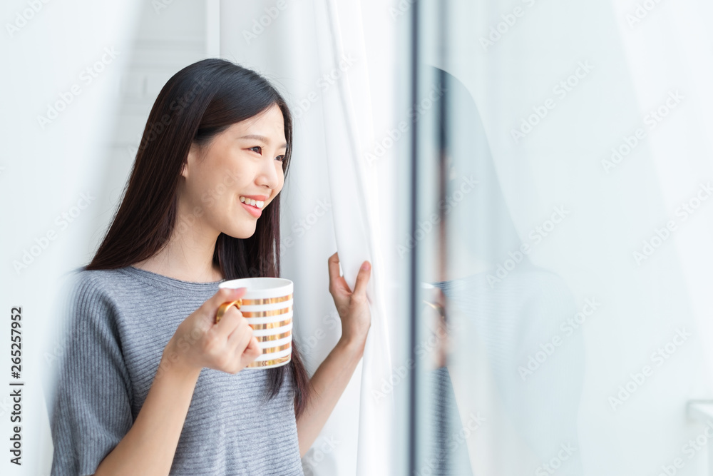 Asian woman drinking coffee in the morning after wake up