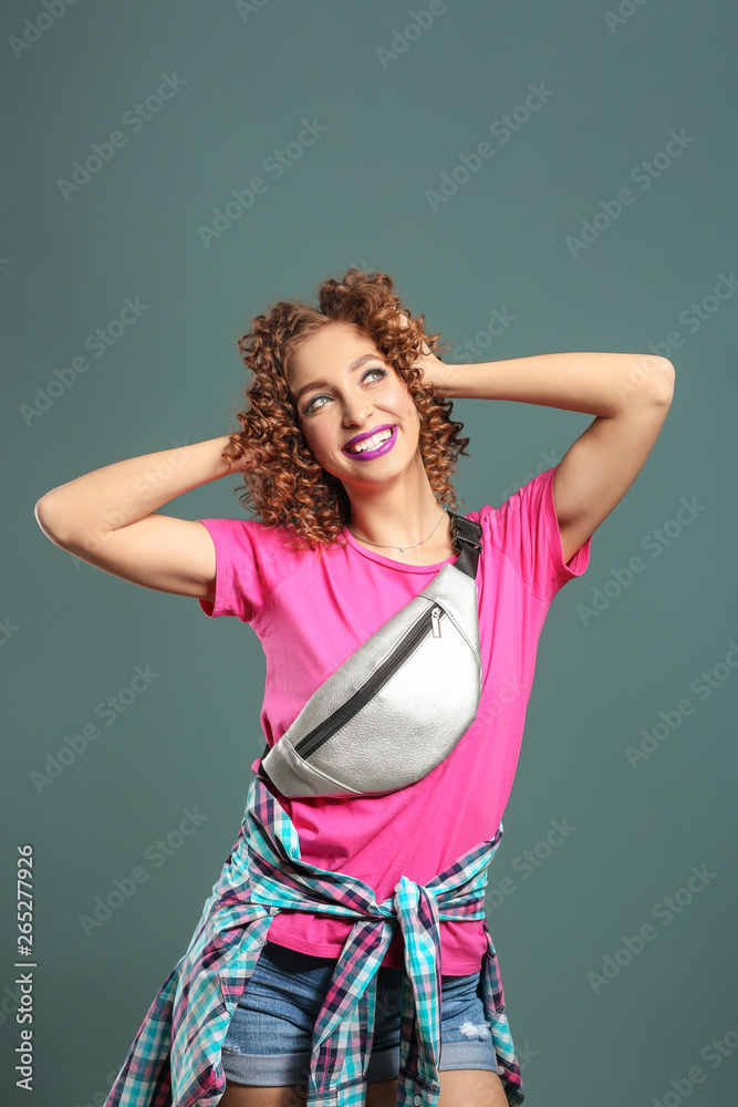 Stylish young woman on grey background