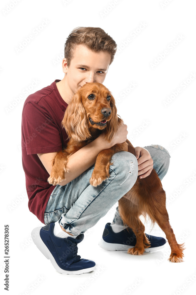 Teenage boy with cute dog on white background