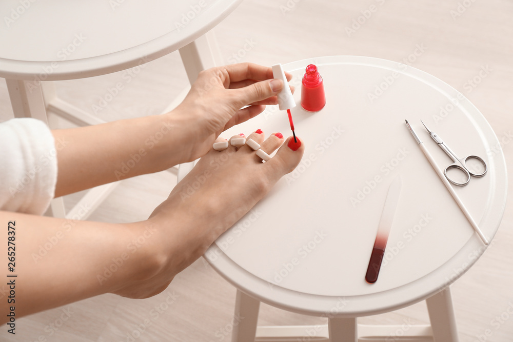 Woman doing pedicure at home