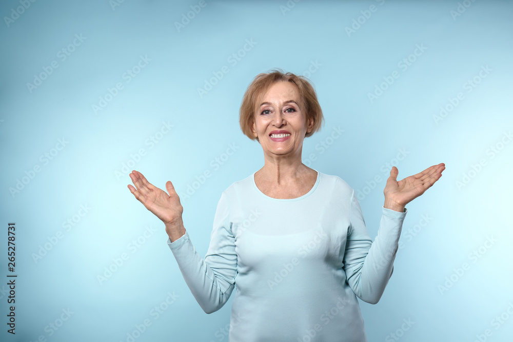 Beautiful mature woman on color background