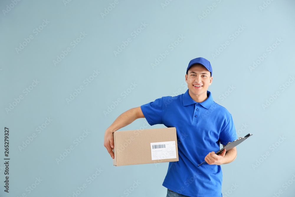 Delivery man with box on color background