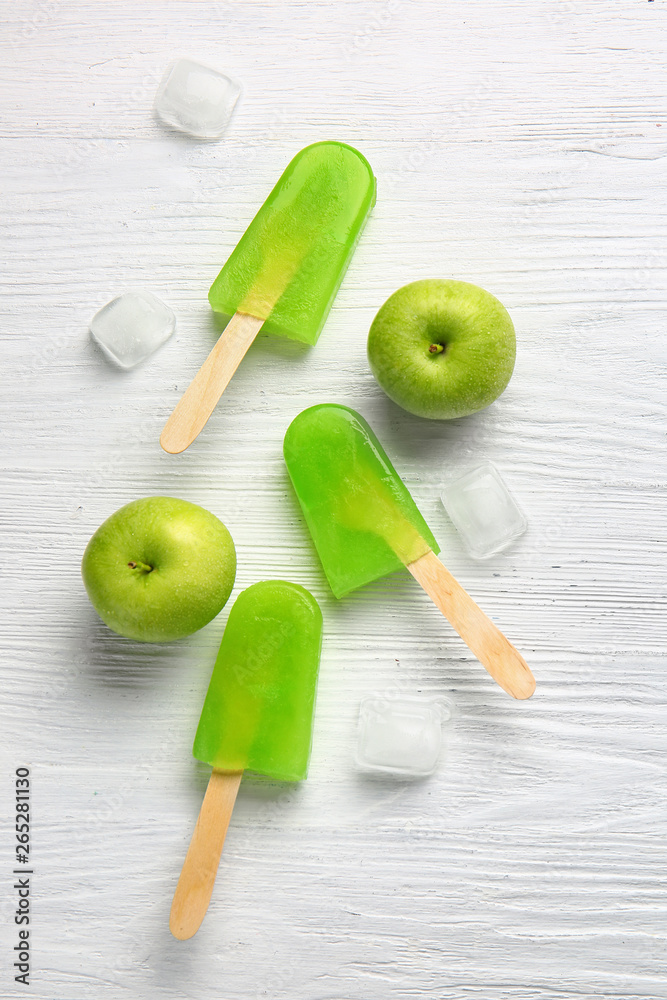 Tasty ice cream and apples on white background