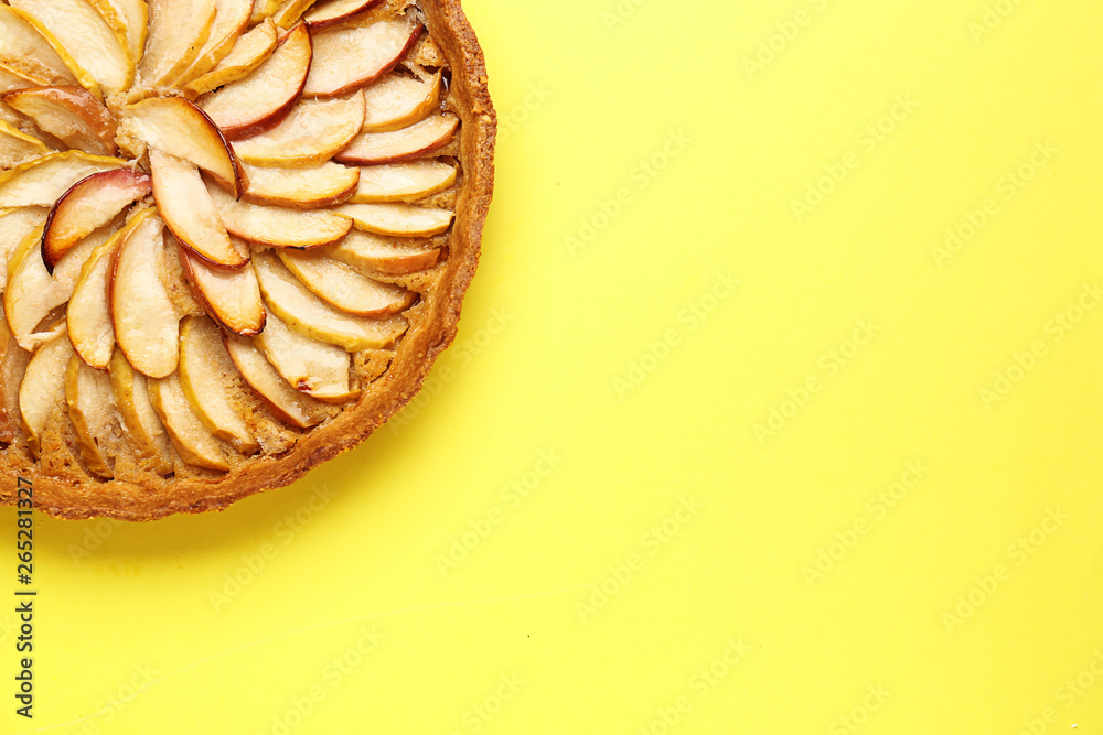 Tasty apple pie on color background