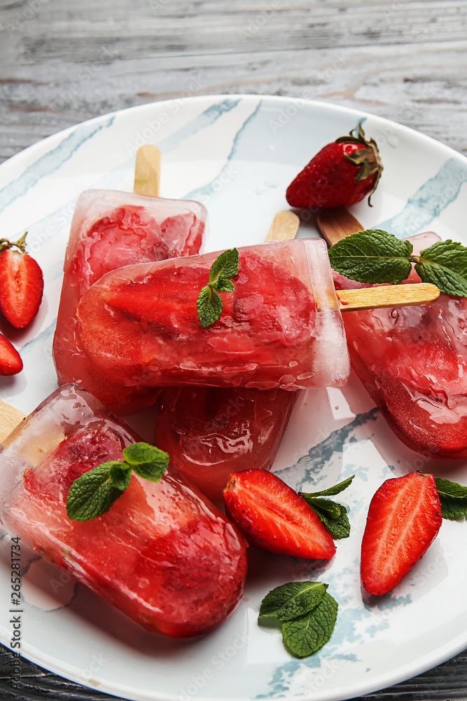 Plate with tasty strawberry ice cream on table, closeup