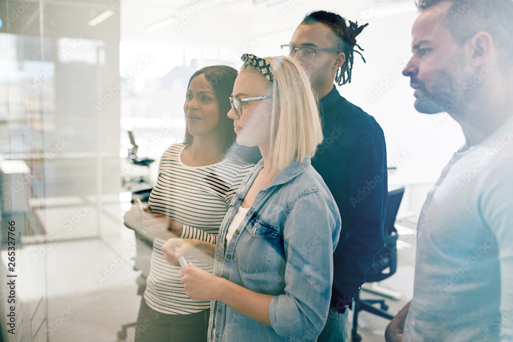 Diverse coworkers brainstorming with sticky notes in an office