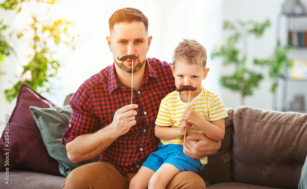  Fathers day. Happy funny family son and dad with mustache .