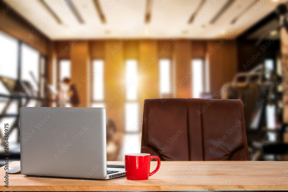 workspace with computer, laptop, office supplies, and coffee cup, smartphone, and tablet at fitness 