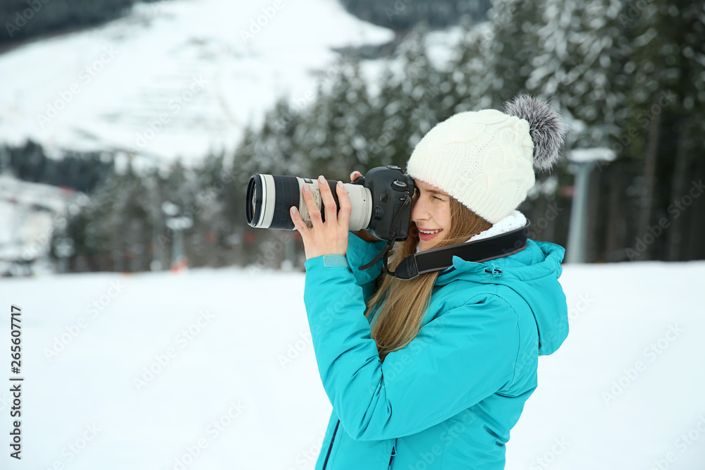 Female photographer at resort on winter day