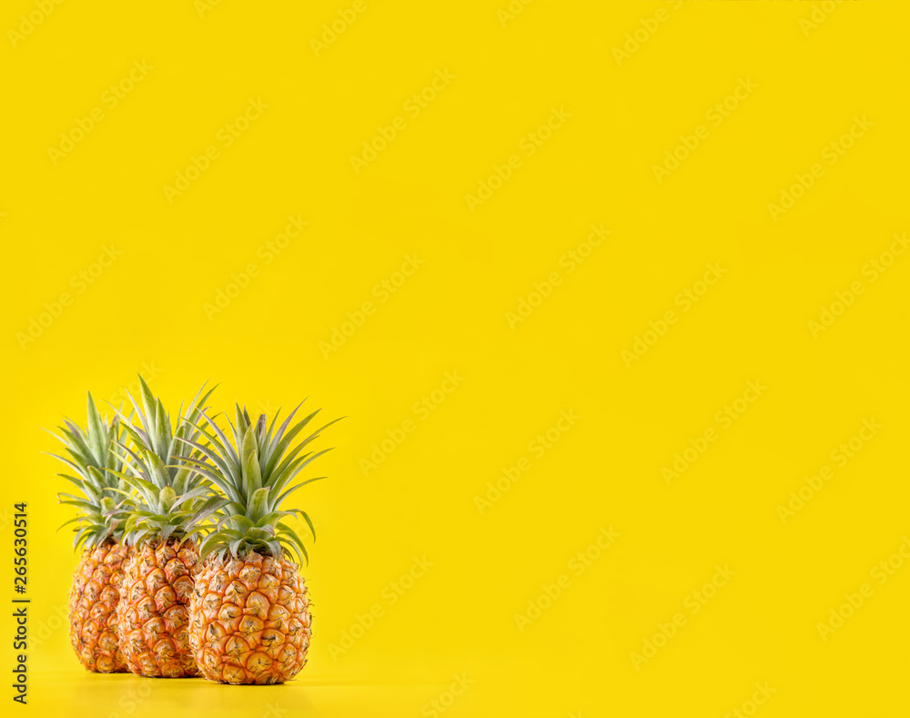 Beautiful fresh pineapple isolated on bright yellow background, summer seasonal fruit design idea pa