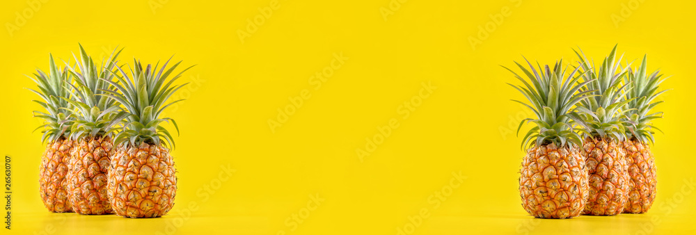 Beautiful fresh pineapple isolated on bright yellow background, summer seasonal fruit design idea pa