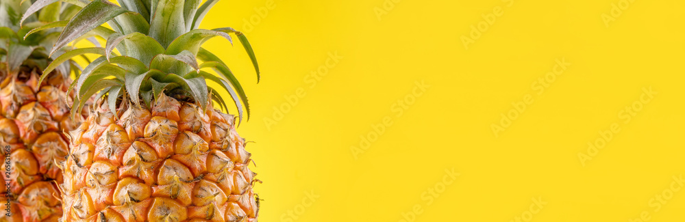 Beautiful fresh pineapple isolated on bright yellow background, summer seasonal fruit design idea pa