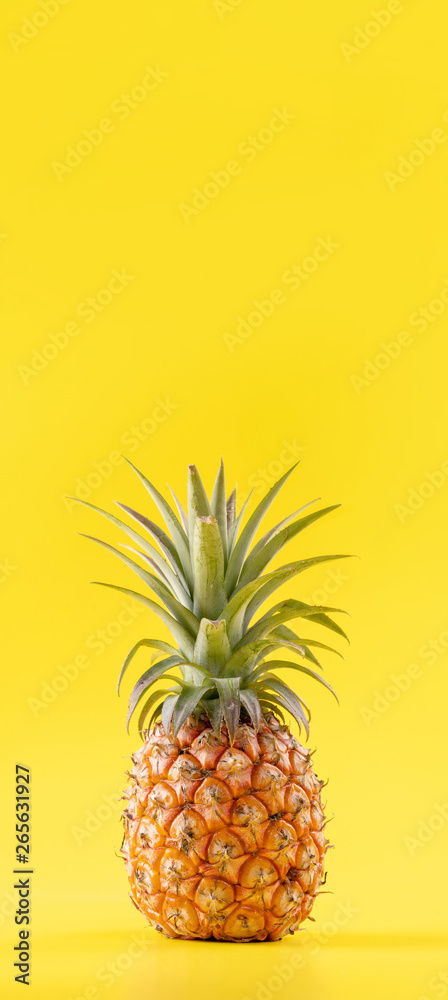 Beautiful fresh pineapple isolated on bright yellow background, summer seasonal fruit design idea pa