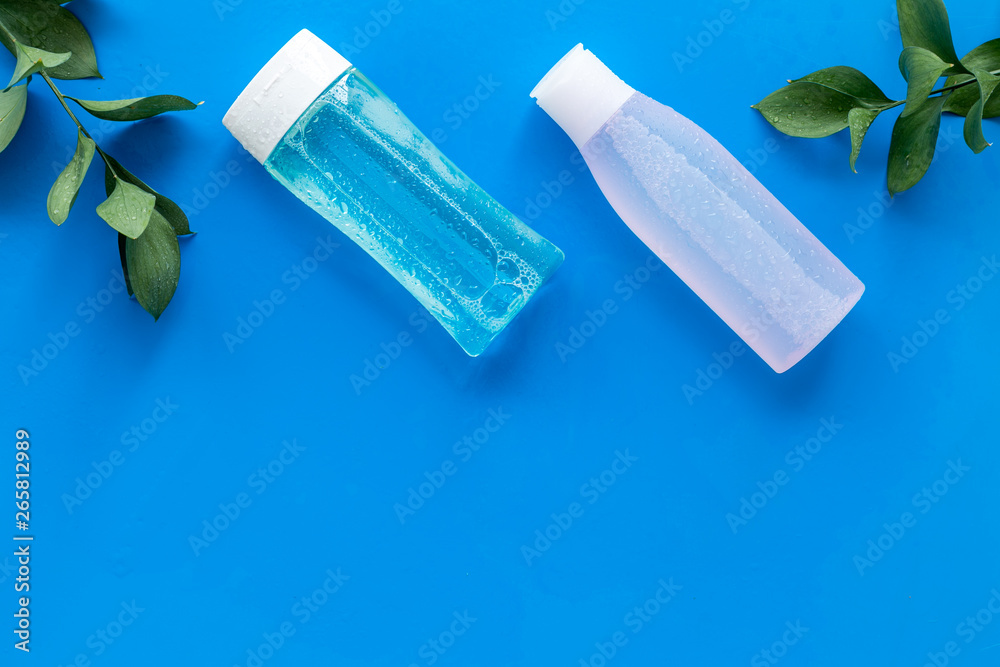 mycelial water, lotion for skin care and plant on blue background flat lay space for text