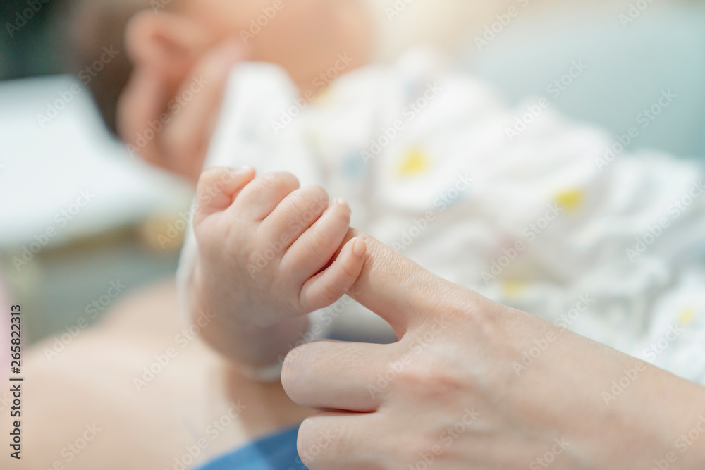 adorable asian cute baby hand hold mom finger love and care family concept