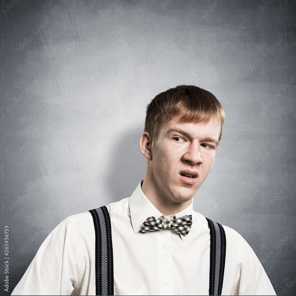 Distrustful redhead teenager looking at camera