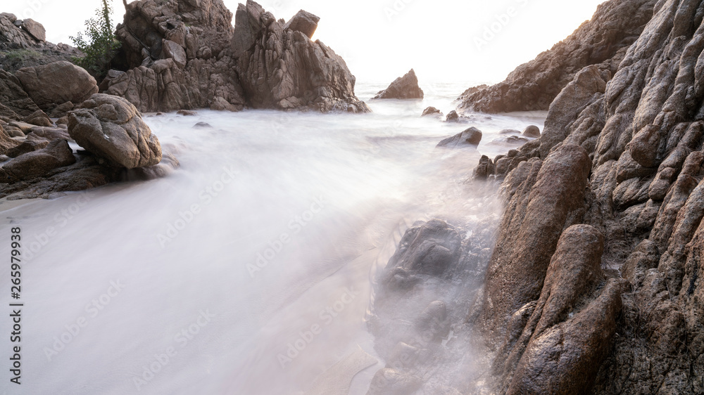 Long exposure image of  wave seascape with rock in scenery background