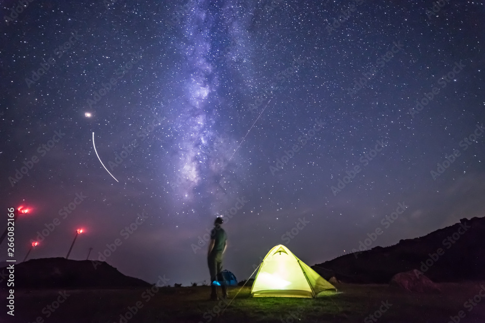 Starry night scene, travel, people climbing the summit