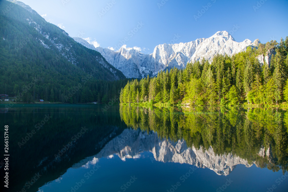 Beautiful morning scene with alpine peaks reflecting in tranquil mountain lake