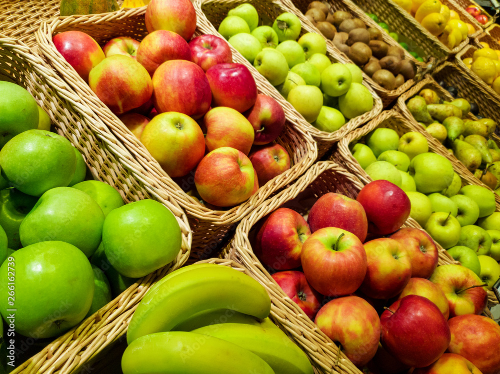 variety of fruits in baskets at grocery store