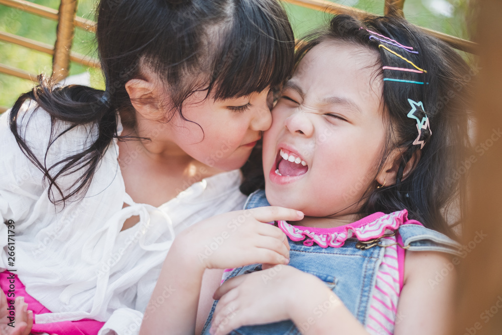 Girl kids kissing friend with happy feel, best friend concept