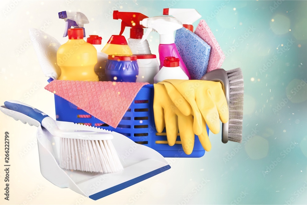 Plastic bottles and  cleaning sponges on background